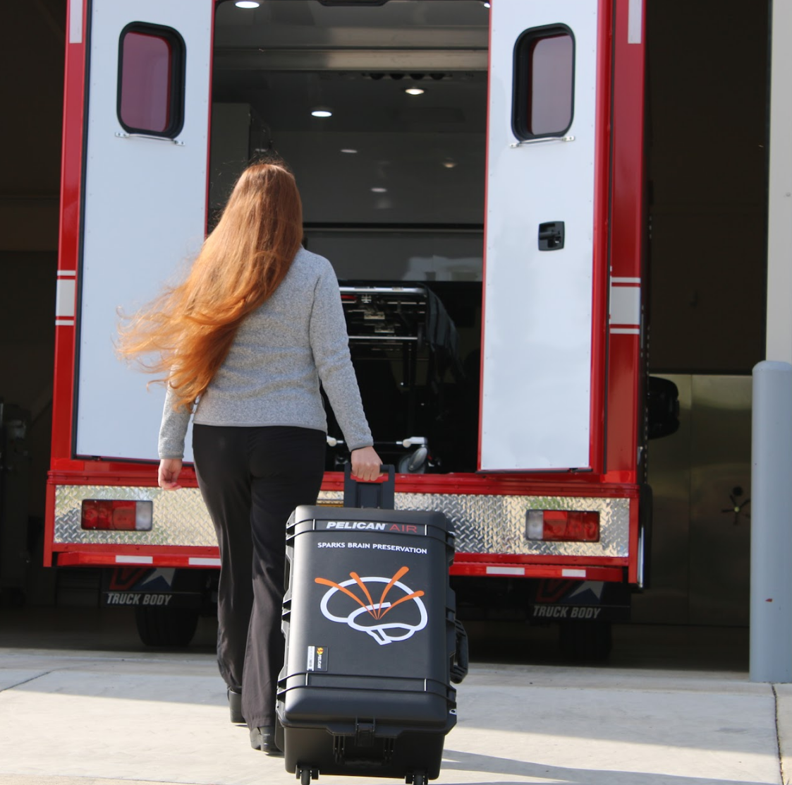 Member of Sparks Brain Preservation's Rapid Response Team walking with a Pelican case