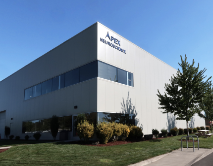 An image of the outside of the Sparks Brain Preservation facility which includes a sign for Apex Neuroscience.